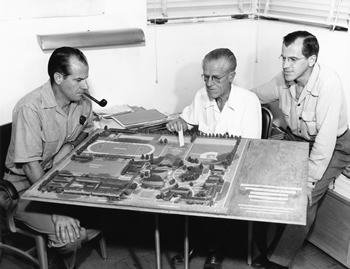 Harry, Roger and E. Stewart Williams study an architectural model of the PSHS campus during the late 1950s. The firm of Williams, Williams & Williams was in charge of the master plan for the complex. Courtesy Palm Springs Historical Society